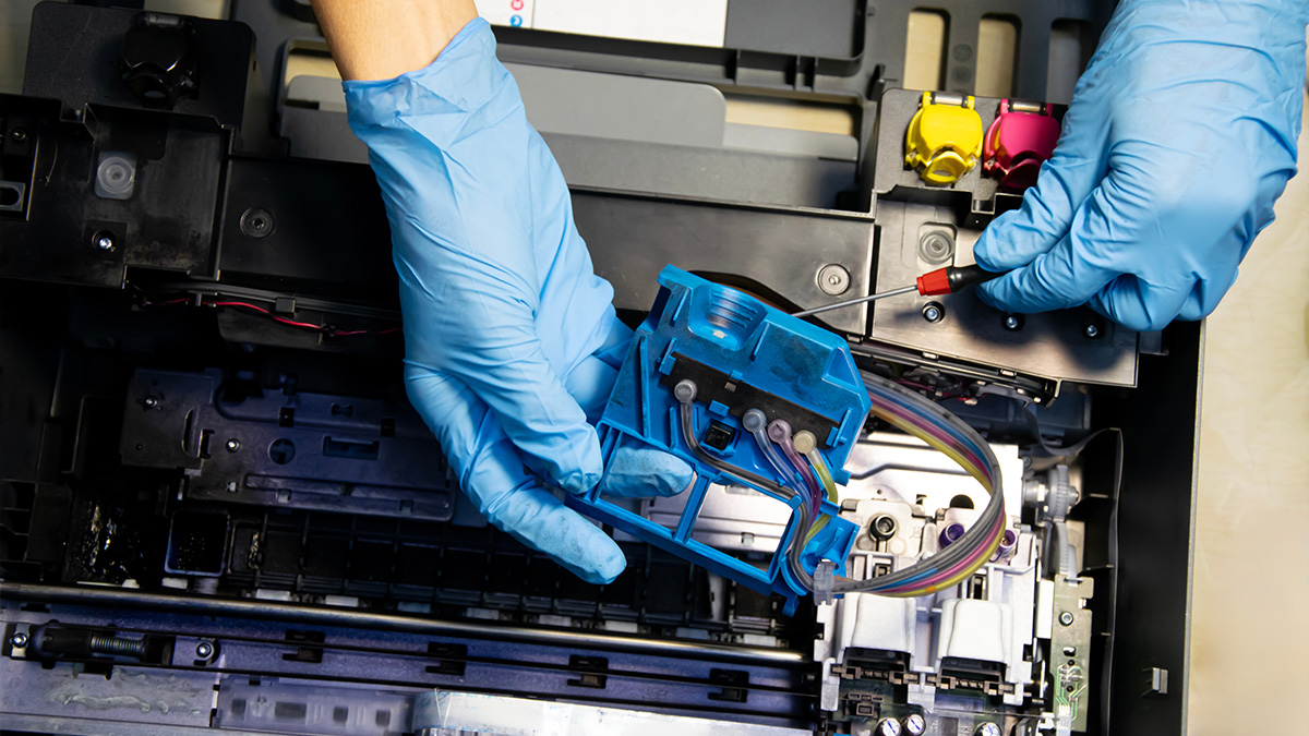 Printer technician fixing a copier machine