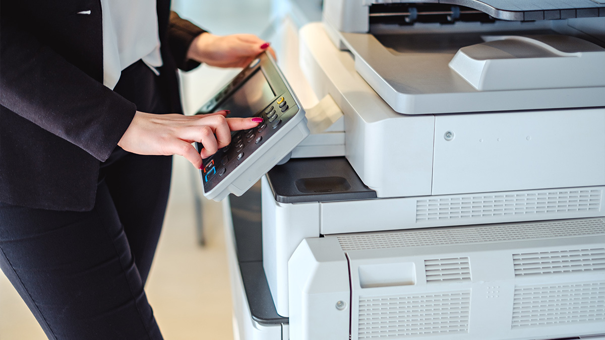 Woman using a multi-function copier machine